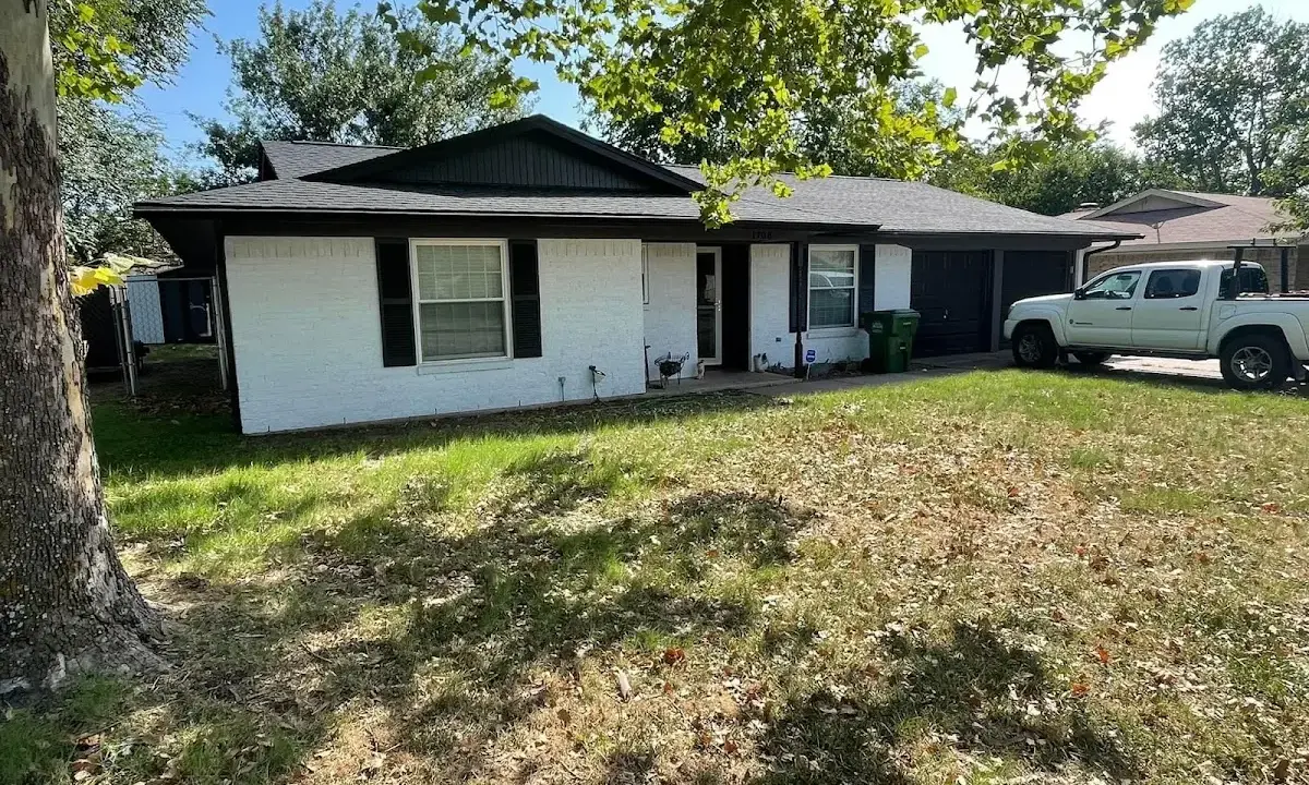Professional roofing crew working on a residential roof in Vinita